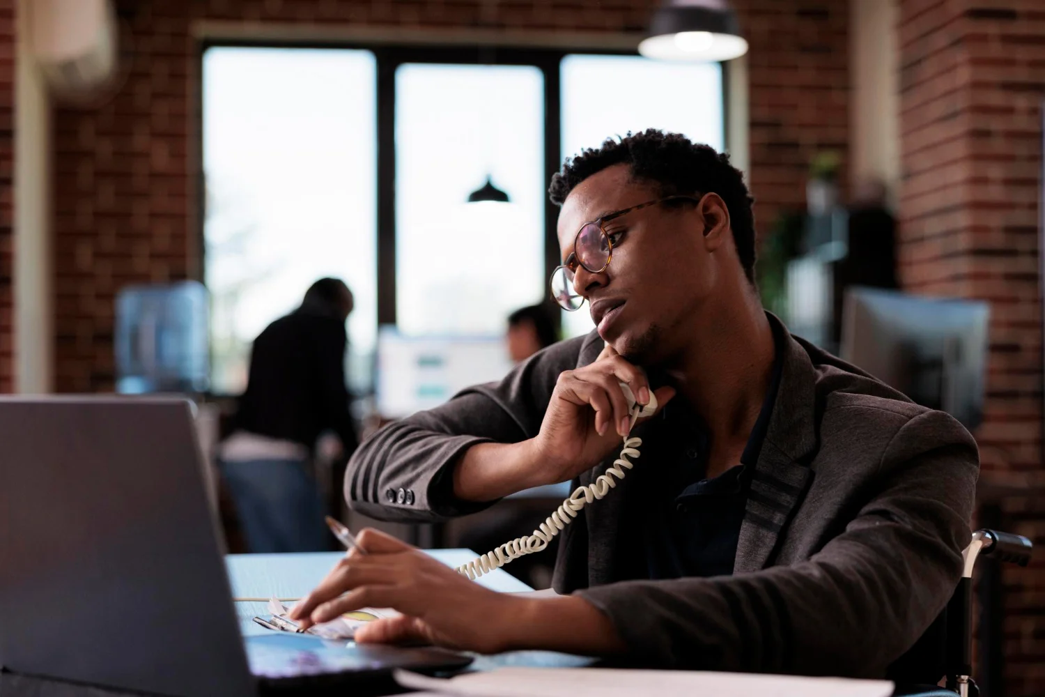 A CallTawk agent taking a call in a loft-style office