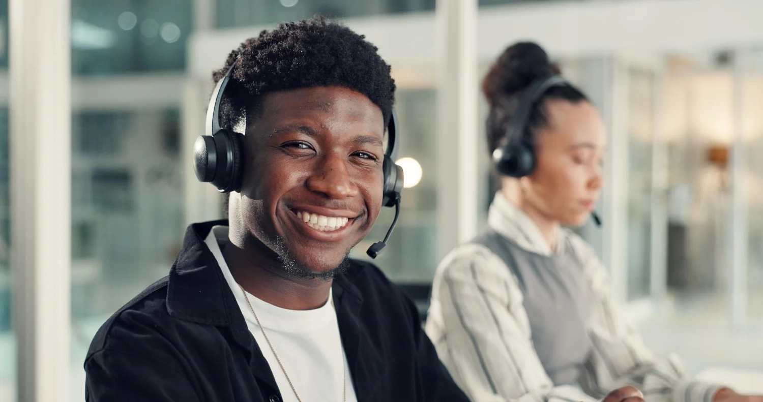 A smiling CallTawk agent wearing a headset