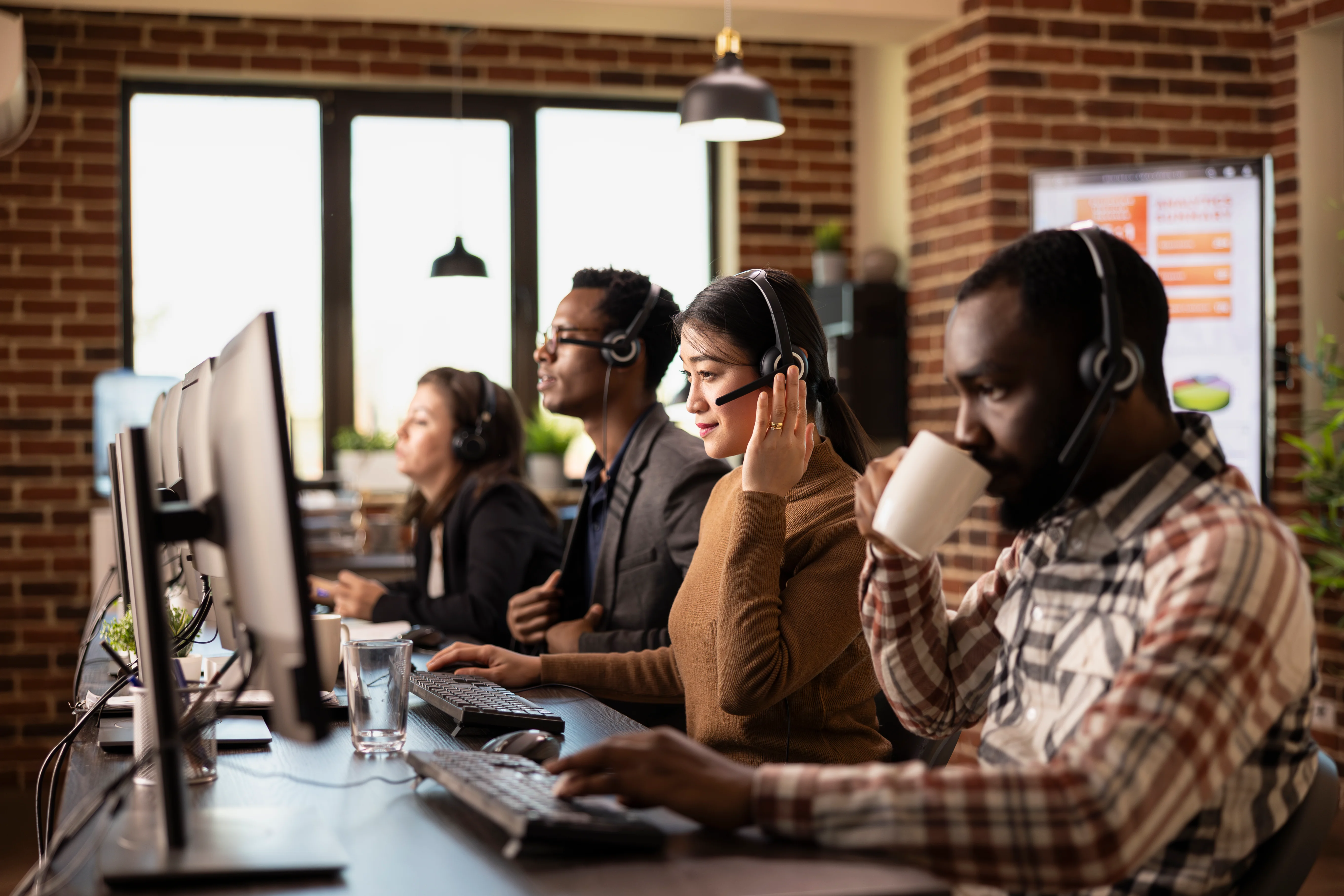 A diverse row of agents working together in a bright office